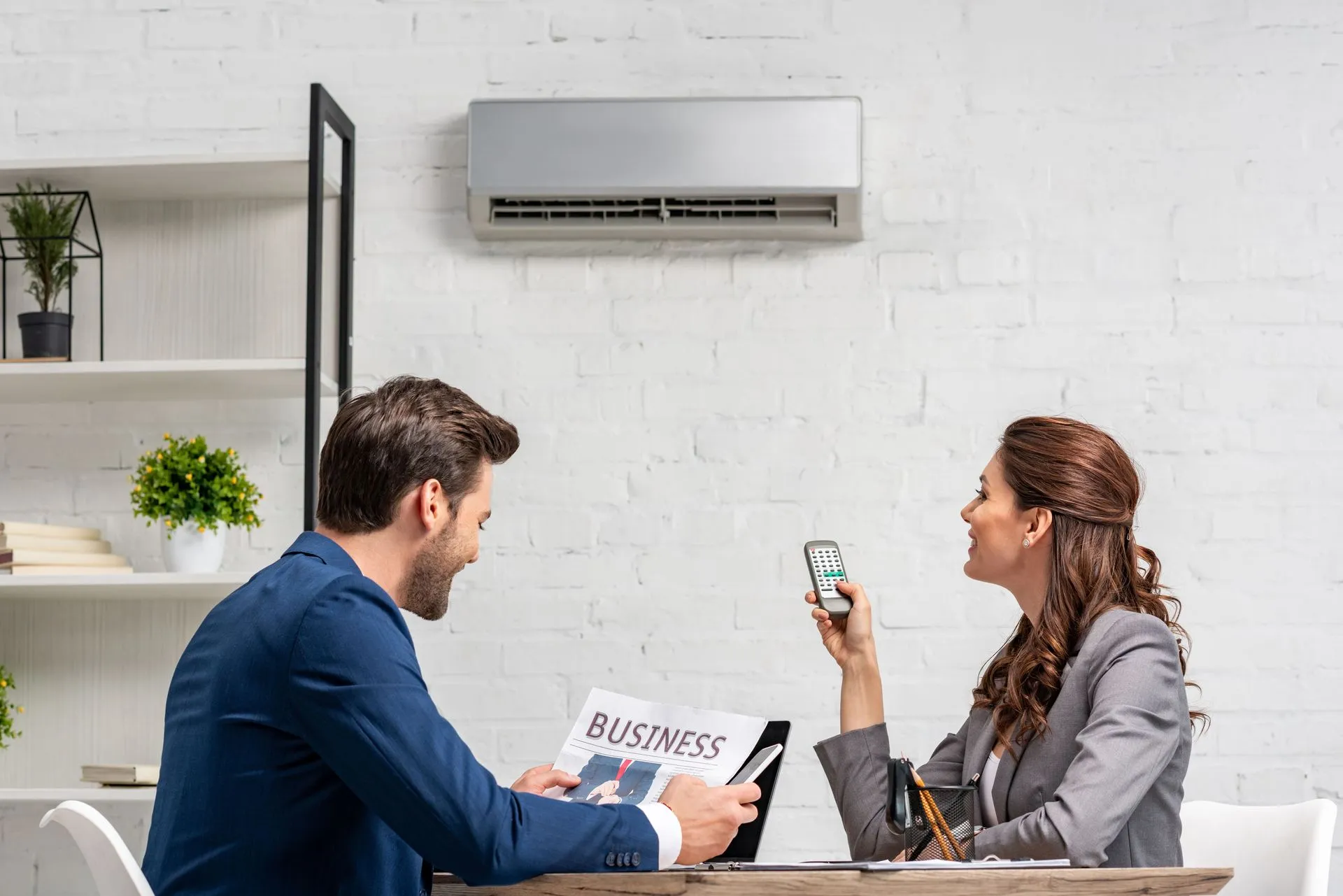 Indoor air quality specialist installing an air purification unit in a home.